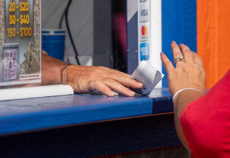 Half-pot tickets are purchased at the 2023 West Side Nut Club Fall Festival in Evansville, Ind., Tuesday, Oct. 3, 2023.