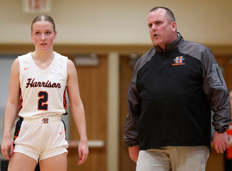 Harrison Raiders Ava Ahnert (2) talks to Harrison Raiders head coach Rush McColley during the IHSAA girl’s basketball game, Wednesday, Nov. 29, 2023, at Harrison High School in West Lafayette, Ind. Harrison won 47-43.