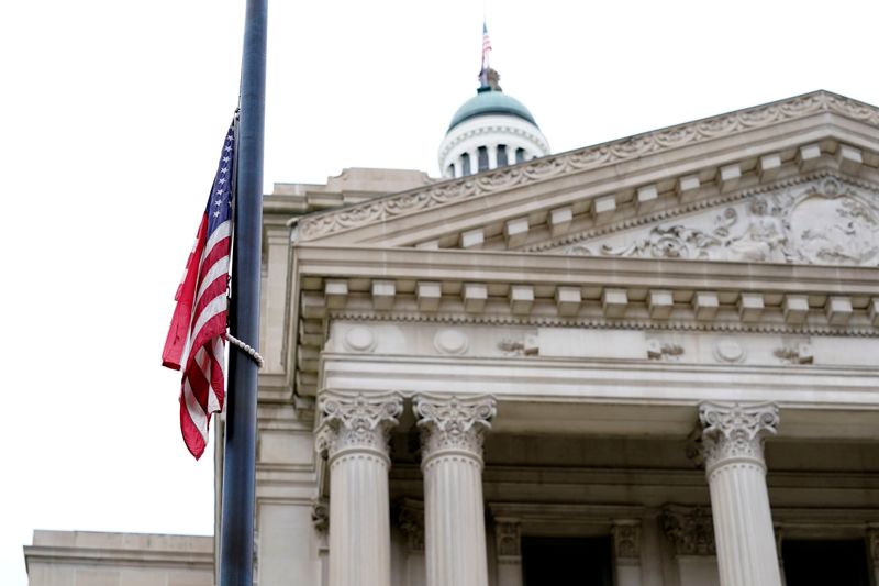 The flag flies at half staff in front of the Indiana State Capitol on Saturday, April 17, 2021, in downtown Indianapolis.