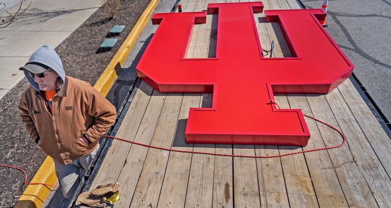 Steve Overbey, with Greenfield Signs, gets ready to help with the installation of a second of two signs of the Indiana University trident symbol Monday, March 11, 2024 atop the IUPUI Campus Center. On July 1, 2024, Indiana University and Purdue University will split on the campus. This building will be the Indiana University Indianapolis Campus Center. Overbey is one of the people who built the signs.