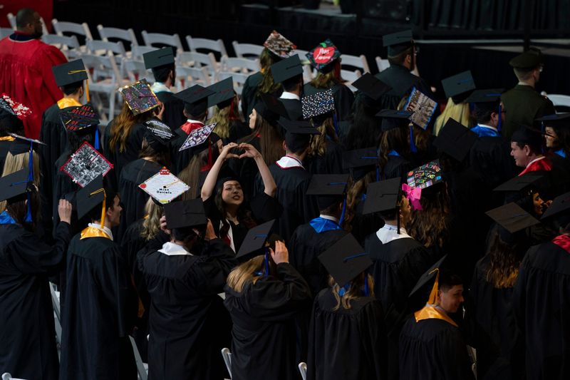 Graduates wave to family during the 2024 Spring Pott College of Science, Engineering and Education commencement ceremony at the University of Southern Indiana Saturday, May 4, 2024.