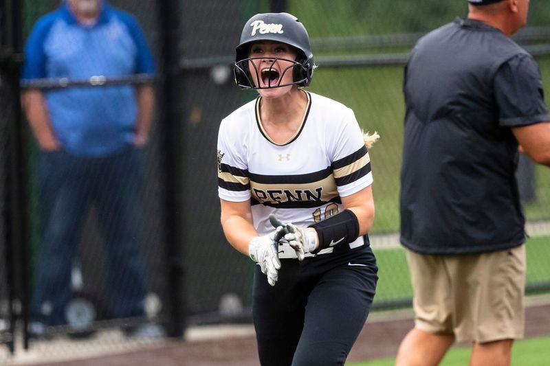 Penn's Logan Rumble (10) celebrates a grand slam as she rounds third base during the Elkhart vs. Penn softball sectional championship game Friday, May 24, 2024 at Northridge High School in Middlebury