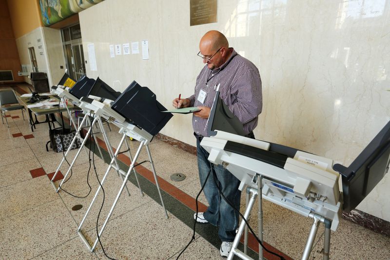 Republican judge Mike Smith balances the votes Thursday, October 15, 2015, at an early voting center on the campus of Purdue University. Smith is concerned about the impacts of mid-decade redistricting.