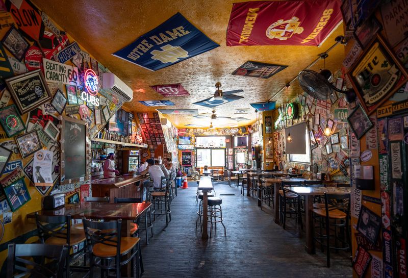 Sam’s Silver Circle is decorated in signs, flags, Sports Illustrated magazines, stickers and license plates from floor to ceiling Wednesday, June 12, 2024. The assorted items have been accumulated by the owners or donated by bar patrons.