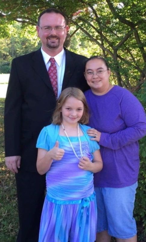Elizabeth Saylor, right, here with her husband, Philip, and adopted daughter Ella, says their relationship with the girl was strong until she ran into problems at school. Ella has run away twice and has been missing from her family in Muncie since January.