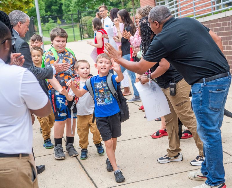 Connor Haney gets high-fives on her way to her first day of school at Fairview Elementary to greet children on the first day of school on Wednesday, Aug. 7, 2024.