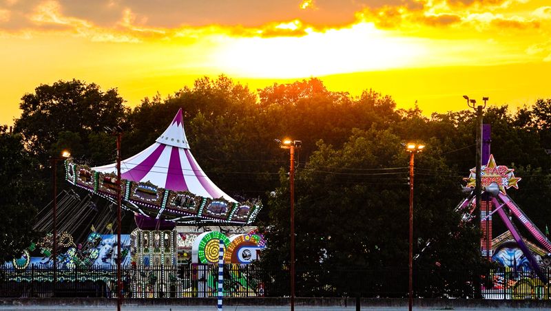 The sun sets on the Indiana State Fair on Wednesday, August. 14, 2024, in Indianapolis.