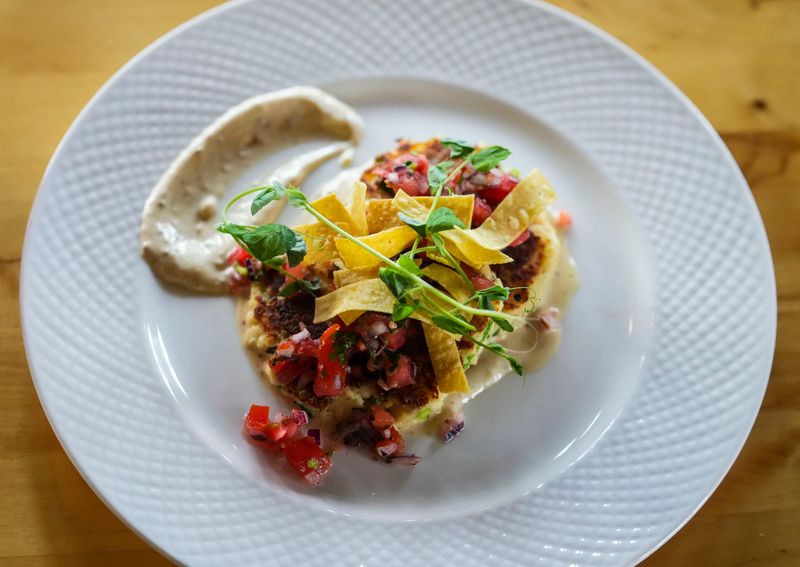 A crab cake dish is prepared Thursday, Sept. 12, 2024, at Parkside Public House next to Garfield Park in Indianapolis.