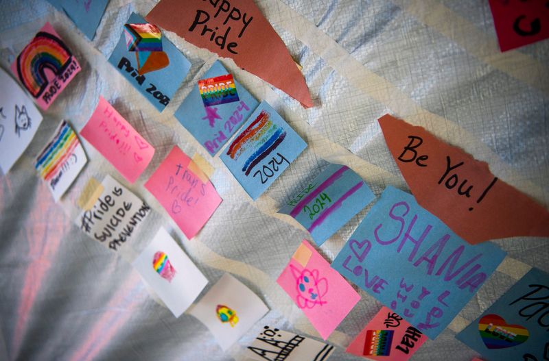 Hand written notes being used to creat a Pride flag mosaic at the Simtra booth during Pridefest along Kirkwood Avenue on Saturday, Sept. 14, 2024.