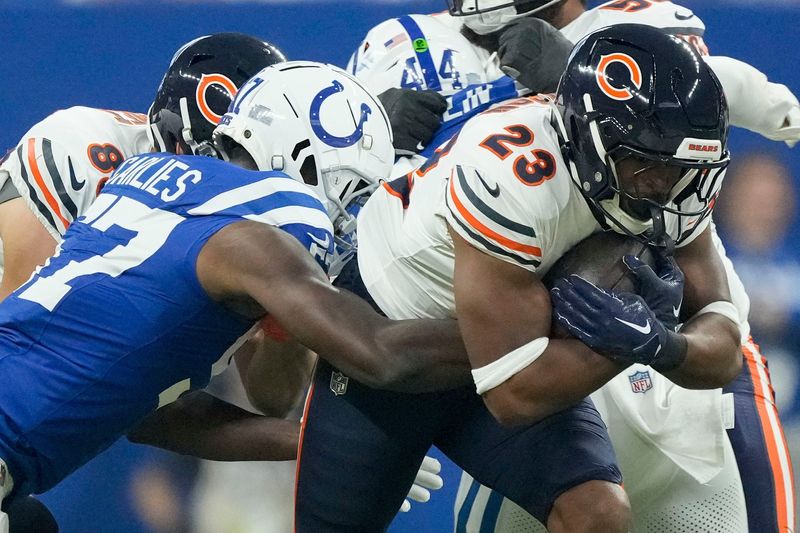 Indianapolis Colts linebacker Jaylon Carlies (57) tackles Chicago Bears running back Roschon Johnson (23) on Sunday, Sept. 22, 2024, during a game against the Chicago Bears at Lucas Oil Stadium in Indianapolis.