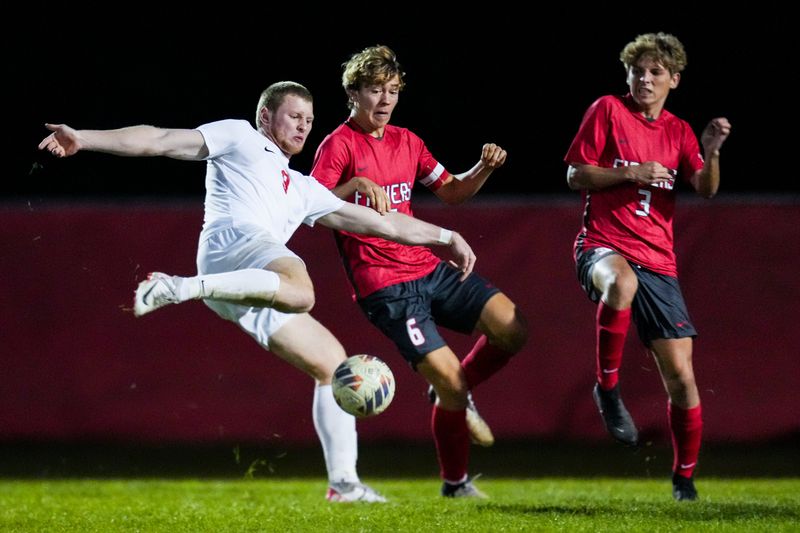 Center Grove Austin Lowden (9) kicks the ball Thursday, Oct. 3, 2024, during a boys soccer game between the Fishers Tigers and Center Grove at Fishers High School. Center Grove defeated Fishers, 2-0.