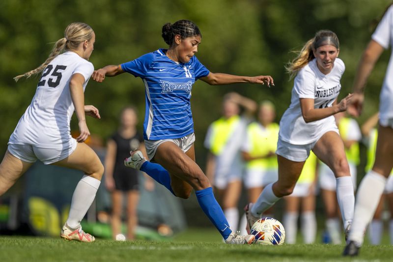 Hamilton Southeastern High School freshman forward Sydney May (11) splits a pair of Noblesville High School defenders during the first half of an IHSAA Girls Soccer Sectional Championship game, Saturday, Oct. 12, 2024, at Noblesville High School.