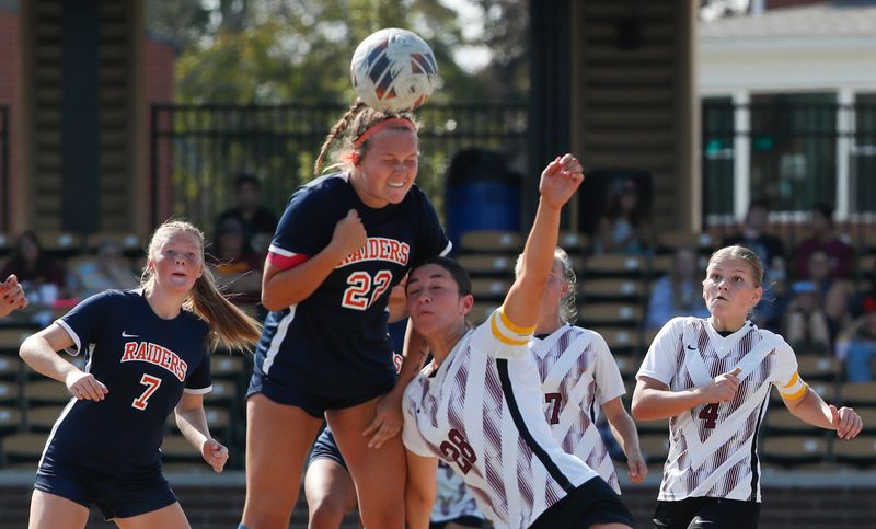 Harrison Raiders defender Libby Sharp (22) and McCutcheon Mavericks defender Kalea Washington (28) go for a header Saturday, Oct. 12, 2024, during the IHSAA girls soccer sectional championship game at Loeb Stadium in Lafayette, Ind. Harrison won 2-1 in extra time.