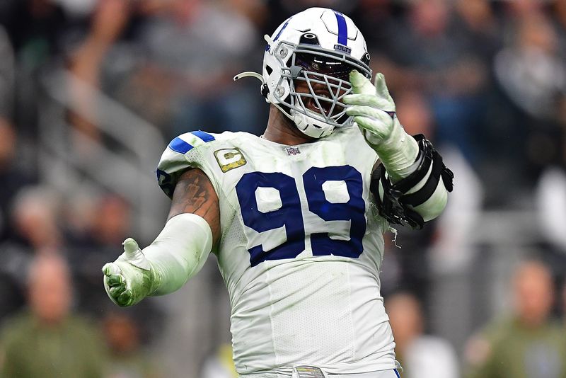 Nov 13, 2022; Paradise, Nevada, USA; Indianapolis Colts defensive tackle DeForest Buckner (99) reacts after sacking Las Vegas Raiders quarterback Derek Carr (4) during the second half at Allegiant Stadium. Mandatory Credit: Gary A. Vasquez-USA TODAY Sports