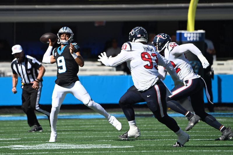Oct 29, 2023; Charlotte, North Carolina, USA; Carolina Panthers quarterback Bryce Young (9) passes the ball as Houston Texans defensive tackle Kurt Hinish (93) and defensive end Jonathan Greenard (52) pressure in the second quarter at Bank of America Stadium. Mandatory Credit: Bob Donnan-USA TODAY Sports