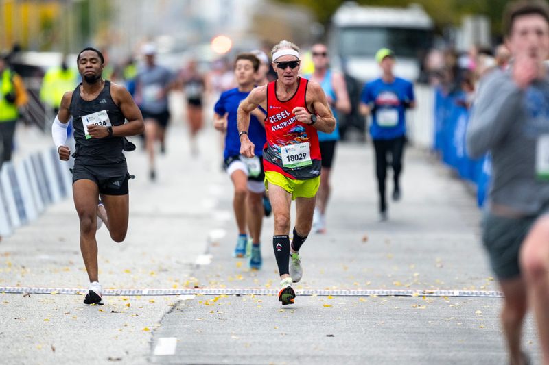 Joseph De Leon, of Kouts, Indiana, center, races toward the finish line. Runners compete in the 17th Annual Indianapolis Monumental Marathon Saturday, Nov. 9, 2024, which begins and ends near the Indiana Statehouse in downtown Indianapolis. The 26.2-mile course, known for its flat, fast route, winds throughout the city.