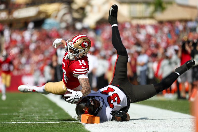 Nov 10, 2024; Tampa, Florida, USA; San Francisco 49ers wide receiver Ricky Pearsall (14) score a touchdown past Tampa Bay Buccaneers safety Antoine Winfield Jr. (31) in the first quarter at Raymond James Stadium. Mandatory Credit: Nathan Ray Seebeck-Imagn Images