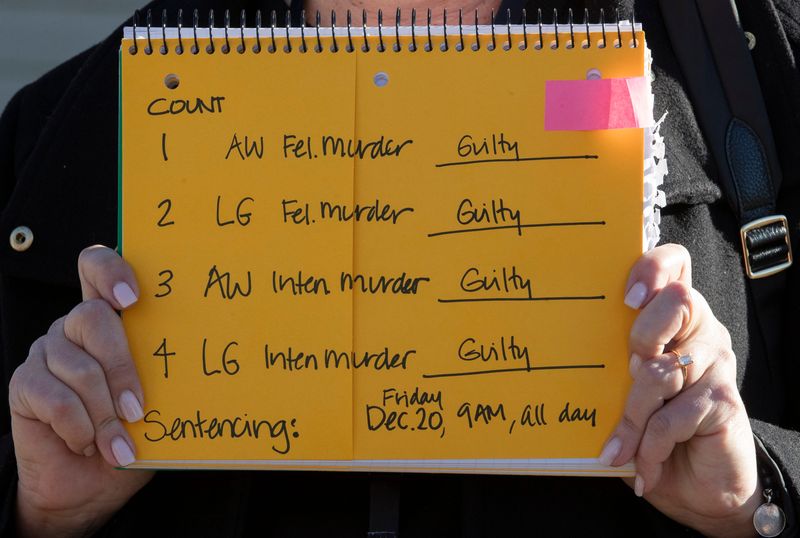 Court TV senior producer Barbara MacDonald holds a sign showing the verdict Monday, Nov. 11, 2024, at the Carroll County Courthouse in Delphi, Ind. Richard Allen was found guilty on all four counts.