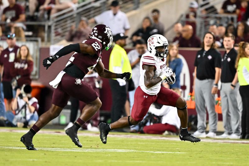 Nov 16, 2024; College Station, Texas, USA; New Mexico State Aggies running back Mike Washington (4) runs the ball during the second half as Texas A&M Aggies linebacker Solomon DeShields (22) defends at Kyle Field. Mandatory Credit: Maria Lysaker-Imagn Images