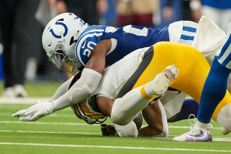 Indianapolis Colts safety Nick Cross (20) tacklesPittsburgh Steelers quarterback Justin Fields (2) on Sunday, Sept. 29, 2024, during a game against the Pittsburgh Steelers at Lucas Oil Stadium in Indianapolis.