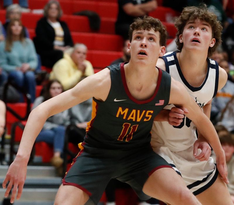 McCutcheon Mavericks Isaac Richardson (11) boxes out Harrison Raiders Ben Slate (30) Saturday, Dec. 7, 2024, during the IHSAA boys basketball game at Lafayette Jeff High School in West Lafayette, Ind. Harrison Raiders won 66-58.
