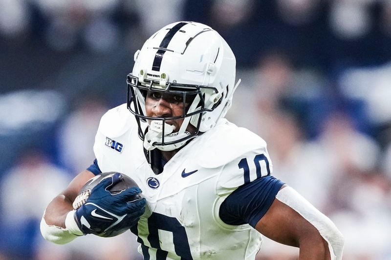 Penn State Nittany Lions running back Nicholas Singleton (10) carries the ball Saturday, Dec. 7, 2024, during the Big Ten Championship game between the Oregon Ducks and the Penn State Nittany Lions at Lucas Oil Stadium in Indianapolis.