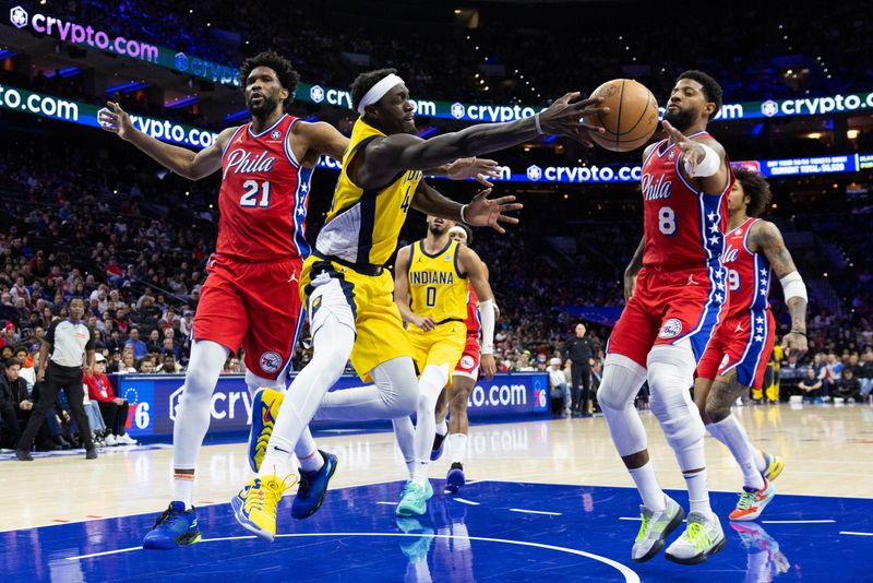 Dec 13, 2024; Philadelphia, Pennsylvania, USA; Indiana Pacers forward Pascal Siakam (43) passes the ball between Philadelphia 76ers forward Paul George (8) and center Joel Embiid (21) during the second quarter at Wells Fargo Center. Mandatory Credit: Bill Streicher-Imagn Images