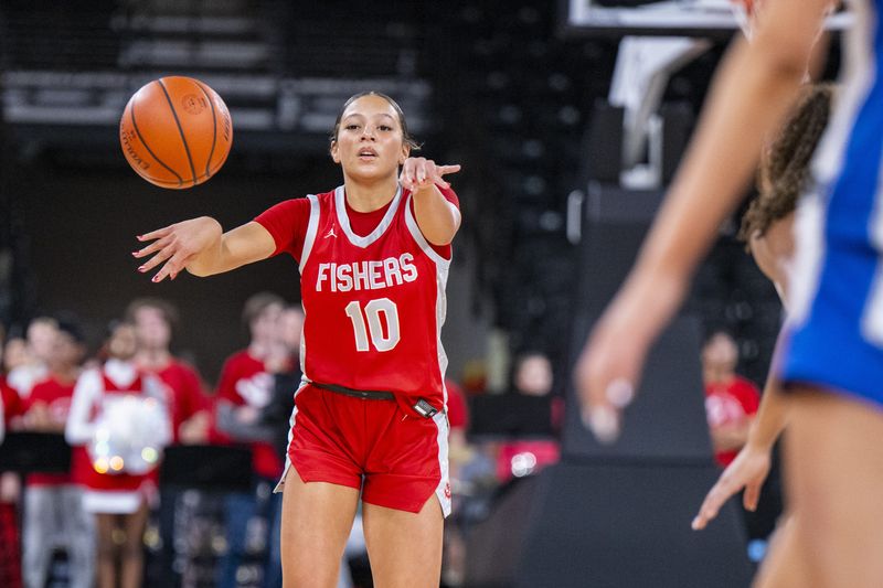 Fishers High School freshman Riley Schellhammer (10) makes a pass during the first half of an IHSAA basketball game against Hamilton Southeastern High School, Friday, Dec. 20, 2024, at Fishers Event Center.