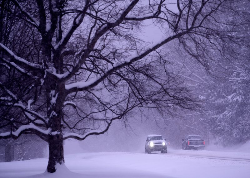 Cars move along Meridian St. during the first major snow of 2025, Monday, Jan. 6, 2025 in Indianapolis.