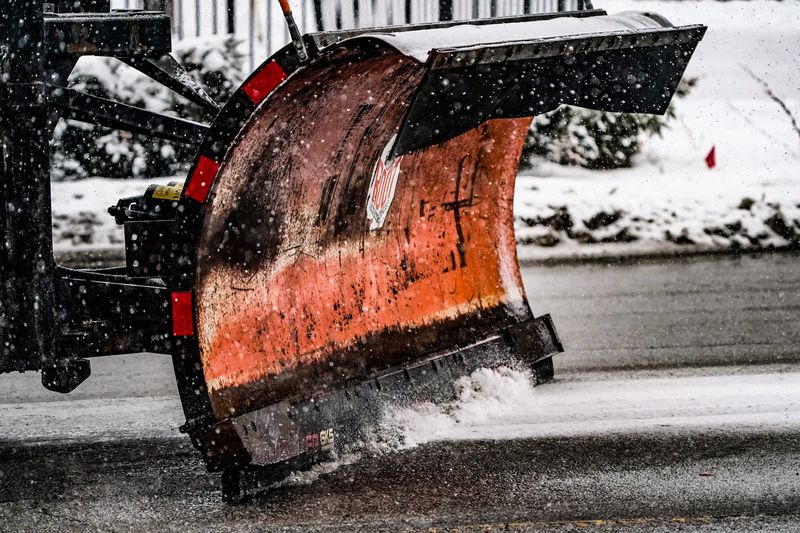 An International Harvester truck plows snow along 16th St. as another wave of heavy snow passes through downtown on Friday, Jan. 10, 2025 in Indianapolis.