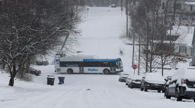 A CityBus drives on Ferry Street Tuesday, Jan. 14, 2025, as snow accumulates in Lafayette, Ind.