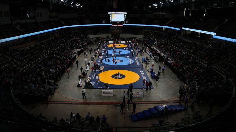 Wrestler take the mat to warm up on Friday, Jan. 17, 2025, during the inaugural IHSAA girls wrestling state finals at Corteva Coliseum at the Indiana State Fairgrounds in Indianapolis.