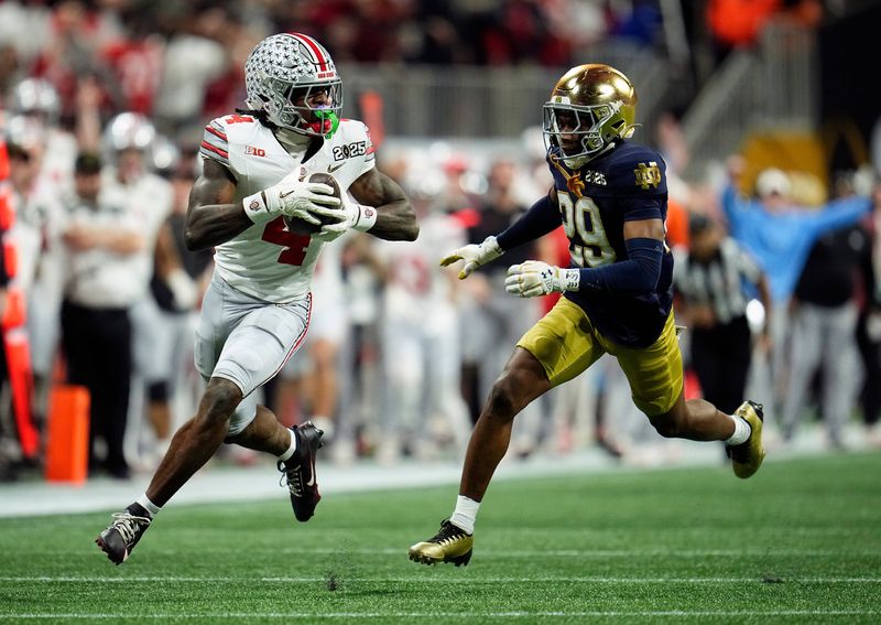 Ohio State Buckeyes wide receiver Jeremiah Smith (4) makes a catch against Notre Dame Fighting Irish cornerback Christian Gray (29) in the fourth quarter during the College Football Playoff National Championship at Mercedes-Benz Stadium in Atlanta on January 20, 2025.