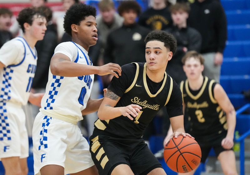 Shelbyville Golden Bears Mar Nicholson (1) rushes past Franklin Community Grizzly Cubs Tony Barnes (0) on Tuesday, Jan. 21, 2025, during the game at Franklin Community High School in Franklin. The Shelbyville Golden Bears defeated the Franklin Community Grizzly Cubs in overtime, 63-58.