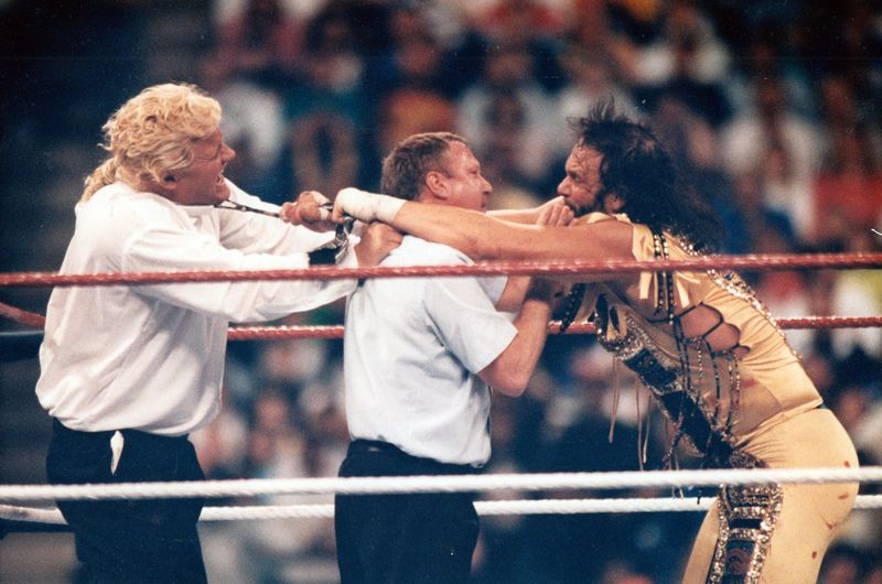 Randy "Macho Man" Savage, right, reaches over a referee to engage with Mr. Perfect during WrestleMania VIII, which was held in April 1992 at the Hoosier Dome. Photos by Susan Plageman/IndyStar