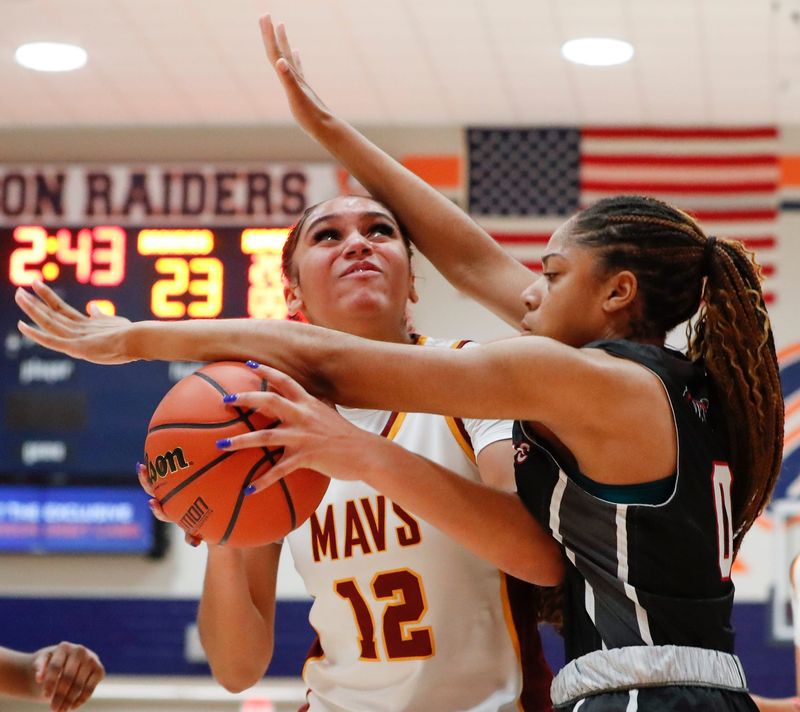 Lafayette Jeff Bronchos forward Da'niyah Johnson (0) defends McCutcheon Mavericks Lillie Graves (12) Saturday, Feb. 8, 2025, during the IHSAA girls basketball sectional championship game at Harrison High School in West Lafayette, Ind. McCutcheon won 51-43.