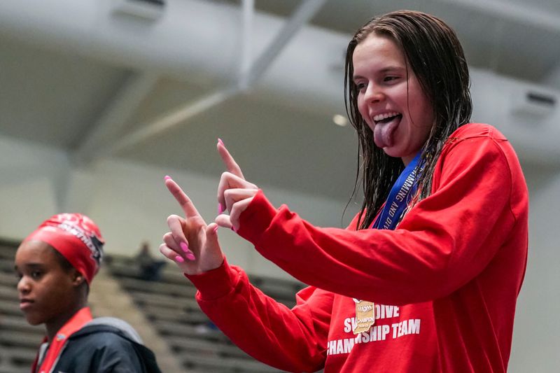 North Central’s Adelyn Flessner celebrates placing first in the 1-meter diving Saturday, Feb. 15, 2025, during the IHSAA girls swimming and diving finals at the IU Natatorium at IU Indianapolis. Carmel won the state title with 448 points.