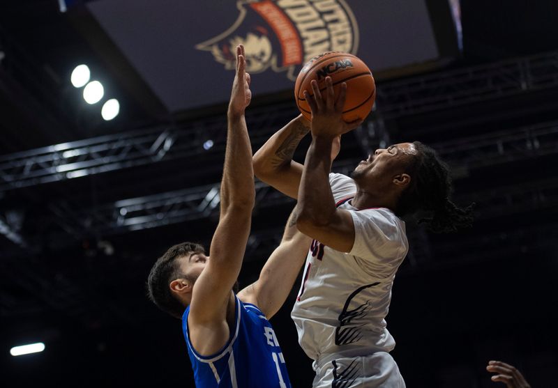 Southern Indiana's Braxton Jones (1) takes a shot against Eastern Illinois' Lazar Grbovic (17) as the University of Southern Indiana Screaming Eagles play the Eastern Illinois Panthers at Liberty Arena in Evansville, Ind., Thursday, Feb. 20, 2025.