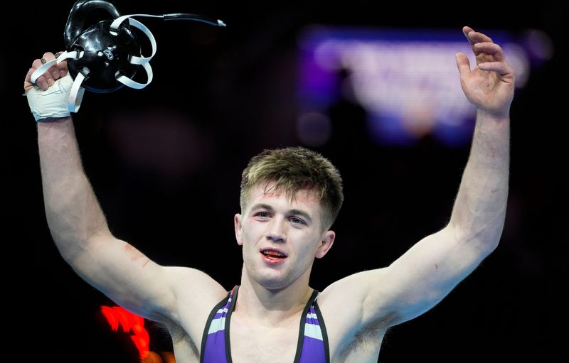 Brownsburg's Parker Reynold's celebrates Portage Michael Ortega in the 150-pound bout Saturday, Feb. 22, 2025, during the IHSAA boys wrestling state finals at Gainbridge Fieldhouse in Indianapolis.