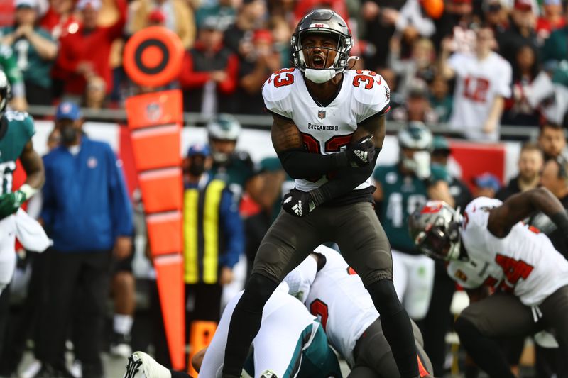 Jan 16, 2022; Tampa, Florida, USA;Tampa Bay Buccaneers free safety Jordan Whitehead (33) celebrates as inside linebacker Devin White (45) sacks Philadelphia Eagles quarterback Jalen Hurts (1) during the first quarter in a NFC Wild Card playoff football game at Raymond James Stadium. Mandatory Credit: Kim Klement-USA TODAY Sports