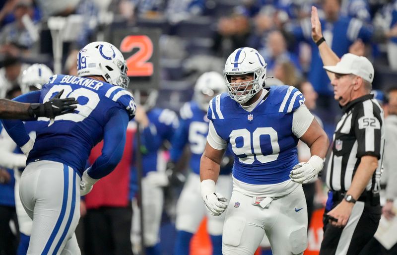Jan 6, 2024; Indianapolis, Indiana, USA; Indianapolis Colts defensive tackle DeForest Buckner (99) and defensive tackle Grover Stewart (90) celebrate after a play against the Houston Texans at Lucas Oil Stadium. Mandatory Credit: Robert Scheer-USA TODAY Sports