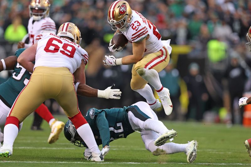 Jan 29, 2023; Philadelphia, Pennsylvania, USA; San Francisco 49ers running back Christian McCaffrey (23) leaps over Philadelphia Eagles safety Marcus Epps (22) on way to a 23-yard touchdown run during the second quarter in the NFC Championship game at Lincoln Financial Field. Mandatory Credit: Bill Streicher-USA TODAY Sports