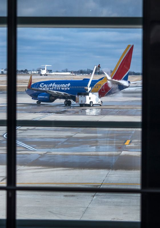 A Southwest Airlines plane is de-iced at a gate Thursday, March 6, 2025 at the Indianapolis International Airport. This is the first day the airline flies nonstop to Nashville, TN. The day was linked to the unveiling of the 2025 Indy 500 ticket with two-time winner Josef Newgarden who is a Nashville native. He and IMS President, INDYCAR President Doug Boles flew on that first flight after the unveiling for an Indy 500 fan event.