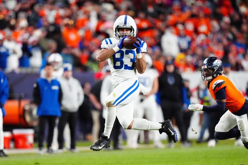Dec 15, 2024; Denver, Colorado, USA; Indianapolis Colts tight end Kylen Granson (83) pulls in a reception in the fourth quarter against the Denver Broncos at Empower Field at Mile High. Mandatory Credit: Ron Chenoy-Imagn Images