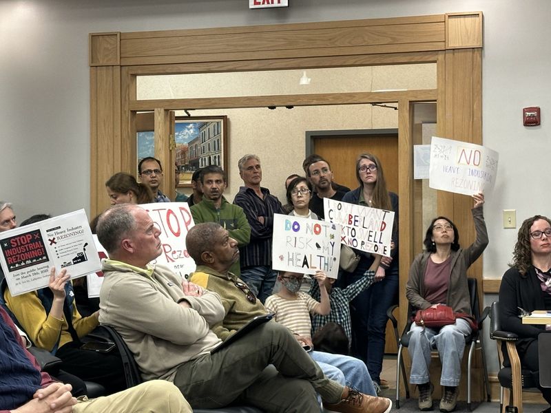 Protesters show their opposition to a proposed rezoning of land for an SK hynix chip manufacturing facility at a West Lafayette City Council meeting in March 2025.