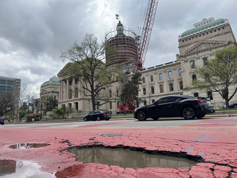 A large pothole sits in the bus lane for the Red and Purple Lines on Capitol Avenue near the Indiana Statehouse on April 21, 2025.