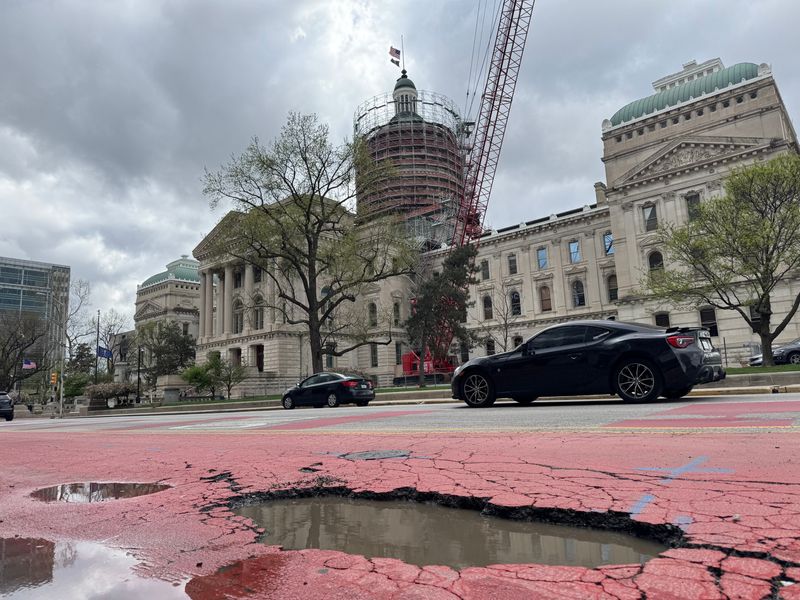 A large pothole sits in the bus lane for the Red and Purple Lines on Capitol Avenue near the Indiana Statehouse on April 21, 2025.