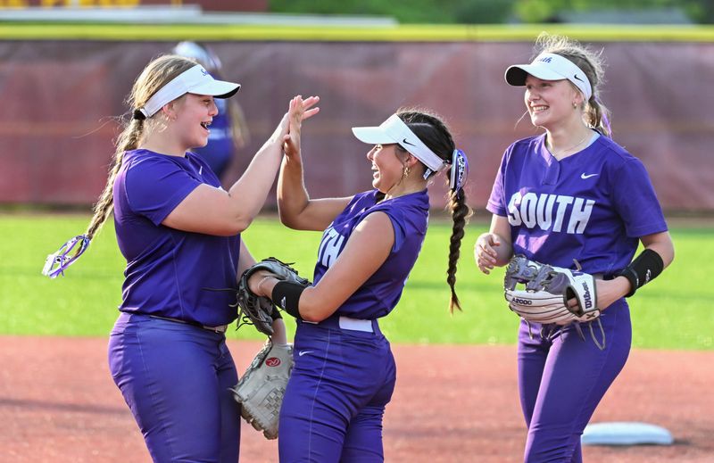 Bloomington South’s Abby Purtlebaugh (left), Carly Reed and Larkyn Ivey celebrate after an out during the softball game at North on Wednesday, April 30, 2025.