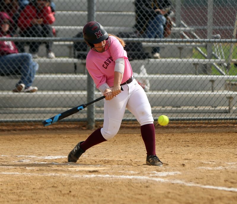 Mishawaka junior Khloe Hershey connects on an RBI base hit during a softball game against South Bend Adams Saturday, May 3, 2025, as part of the Cavemen vs. Cancer Classic at Baker Park in Mishawaka.