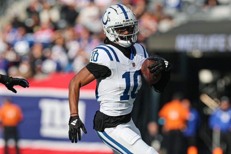 Dec 29, 2024; East Rutherford, New Jersey, USA; Indianapolis Colts wide receiver Adonai Mitchell (10) gains yards after catch during the first half against the New York Giants at MetLife Stadium. Mandatory Credit: Vincent Carchietta-Imagn Images